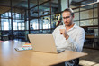 © Drobot Dean - Photo of handsome young man working with laptop while sitting