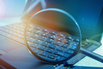 laptop computer with magnifying glass