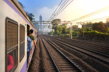 Mumbai, India, Due To Overcrowding, People Travel In Open Doors. Mumbai Suburban Railway Known As Super-Dense Crush Load And Most Severe Overcrowding In The World