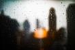 Raindrops on glass with blurred backdrop of skyscrapers