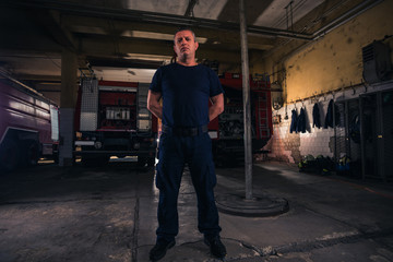 Portrait of fireman standing inside the fire department