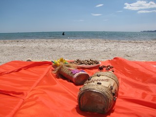 
decorated bottle in the sand by the sea