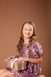 © Julie Boro - girl in a festive dress holds a box with a gift