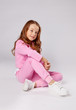© Julie Boro - girl in a pink tracksuit sits on the floor