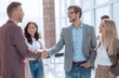 © ASDF - business partners shaking hands, greeting each other.