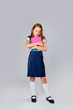 © Julie Boro - cute girl in school uniform holds school notebooks in hands