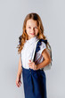 © Julie Boro - cute girl in a school uniform and with a backpack behind