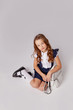 © Julie Boro - cute schoolgirl sitting on the floor next to a backpack