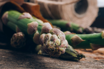 Wall Mural - Bunch of fresh asparagus on wooden table