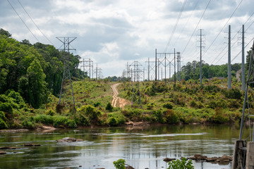 a group overhead high voltage power lines crossing a body of water