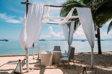 Poster - chair in arch on a beach