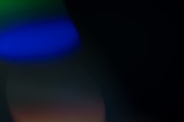 Wall Mural - abstract image of blue light leak and overlay against a black background