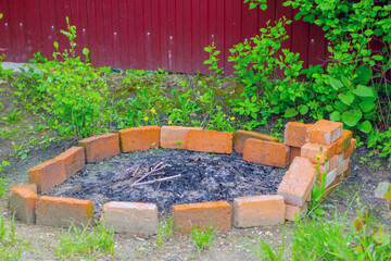 bricked bonfire site. Fire safety. Destruction of wood waste.