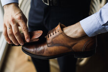 Man Polishing Leather Shoes With Brush At Home