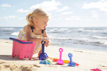 Summer Vacation. Adorable Toddler Girl Playing With Beach Toys On The Sandy Beach.