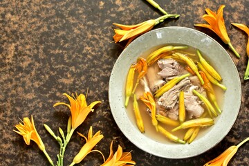 Wall Mural - Asian soup with daylily flowers (golden needles) and pork. Chinese cuisine. young daylily buds, edible flowers, foraging. daylily recipe. Pork  with Golden Needle