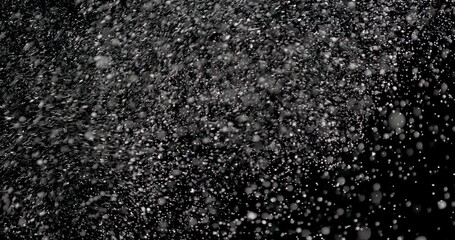 Wall Mural - snowflakes floating in the air slowly at night. it shows the white particles dropping from above slo