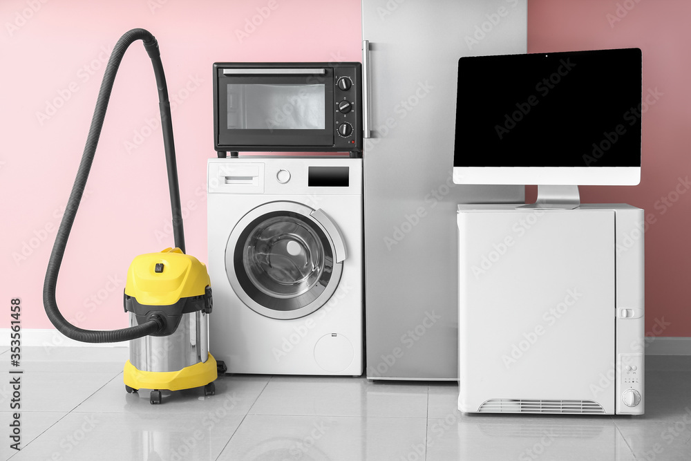 Different household appliances near color wall