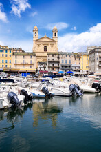 View On église Saint Jean-Baptiste In Bastia From The Vieux Port With Some Boats Resting In The Habour During Summertime
