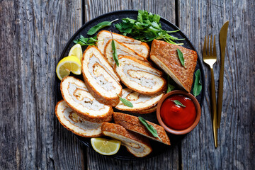 Wall Mural - Baked Omelet Roll on a black plate