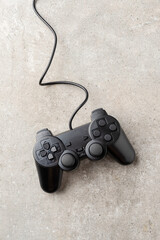 Wall Mural - Overhead shot of video game controller on stone background. Close up