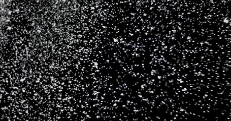 Wall Mural - cloud of shiny snowflakes floating in the air. the shot was taken while the snowflakes were on an is