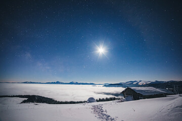 Wall Mural - view at the starry sky over snowy hills. location place carpathian mountains, ukraine, europe.