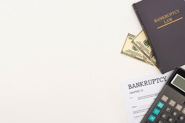 Wall Mural - top view of bankruptcy paper and law book, money and calculator on white background