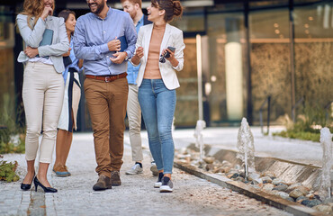 Wall Mural - Young, urban group of bussinespeople walking