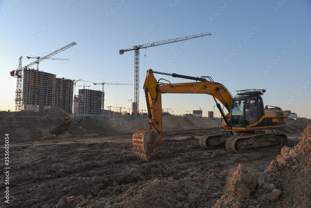 Excavator working at construction site on earthworks. Backhoe digging ...