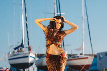 Girl in a beach suit in front of boat