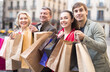 © caftor - parents with older children rejoice with many shopping packages after successful shopping