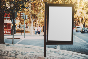 Mockup of an empty ad billboard in urban settings near a road junction; a blank vertical street banner template on paving-stone of the sidewalk; an outdoor poster placeholder mock-up next to the road