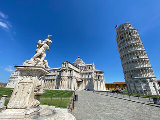 Wall Mural - Cherub statue that sits on the Field of Miracles in Pisa, Tuscany.Famous leaning tower in the background