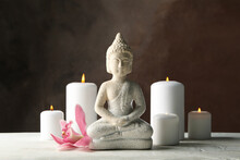 Composition With Buddha And Candles On Wooden Table. Zen Concept