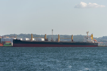 empty container cargo ship at sea industrial pier