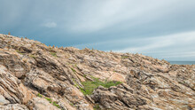 Rocky Hillside With Blue And White Sky, At The Island Of Koh Samet