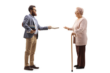 Man giving a book to an elderly woman