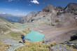 © Bastian Linder - Hiking person at turquoise lake Gradensee at Nossberger Hut, mountains and valley, in Gradental in national park Hohe Tauern, Austria.