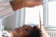 © Jamie Grill Photography/Tetra Images - Close up of young woman playing with her hair