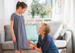 © Tetra Images - Grandmother attaching sewing pins to granddaughter's (8-9) dress