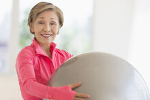 Senior Woman Exercising With Fitness Ball