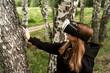 © Maxim - girl in virtual glasses touches a tree with a surprised face
