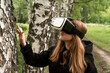 © Maxim - girl in virtual reality glasses touches the grass