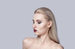 © Evgenia - Bright make-up in a woman with bare shoulders. Stylish haircut.