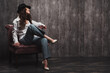 © Aleksey - beautiful girl in a man's shirt is sitting on a chair and laughing