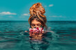 © zolotareva_elina - beautiful young woman swimming in sea with wreath conceptual fashion portrait