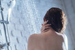 © torwaiphoto - Woman's back taking a shower She feels relaxed