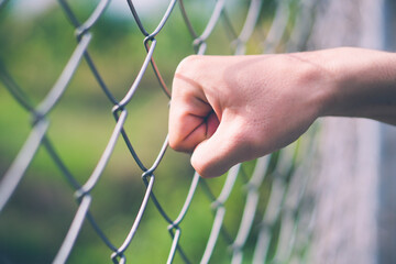 Hand punch hit at Wire Mesh Fence for freedom