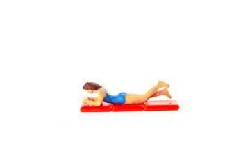 Miniature people office, worker and swimming beach sport concept in variety action on white background 